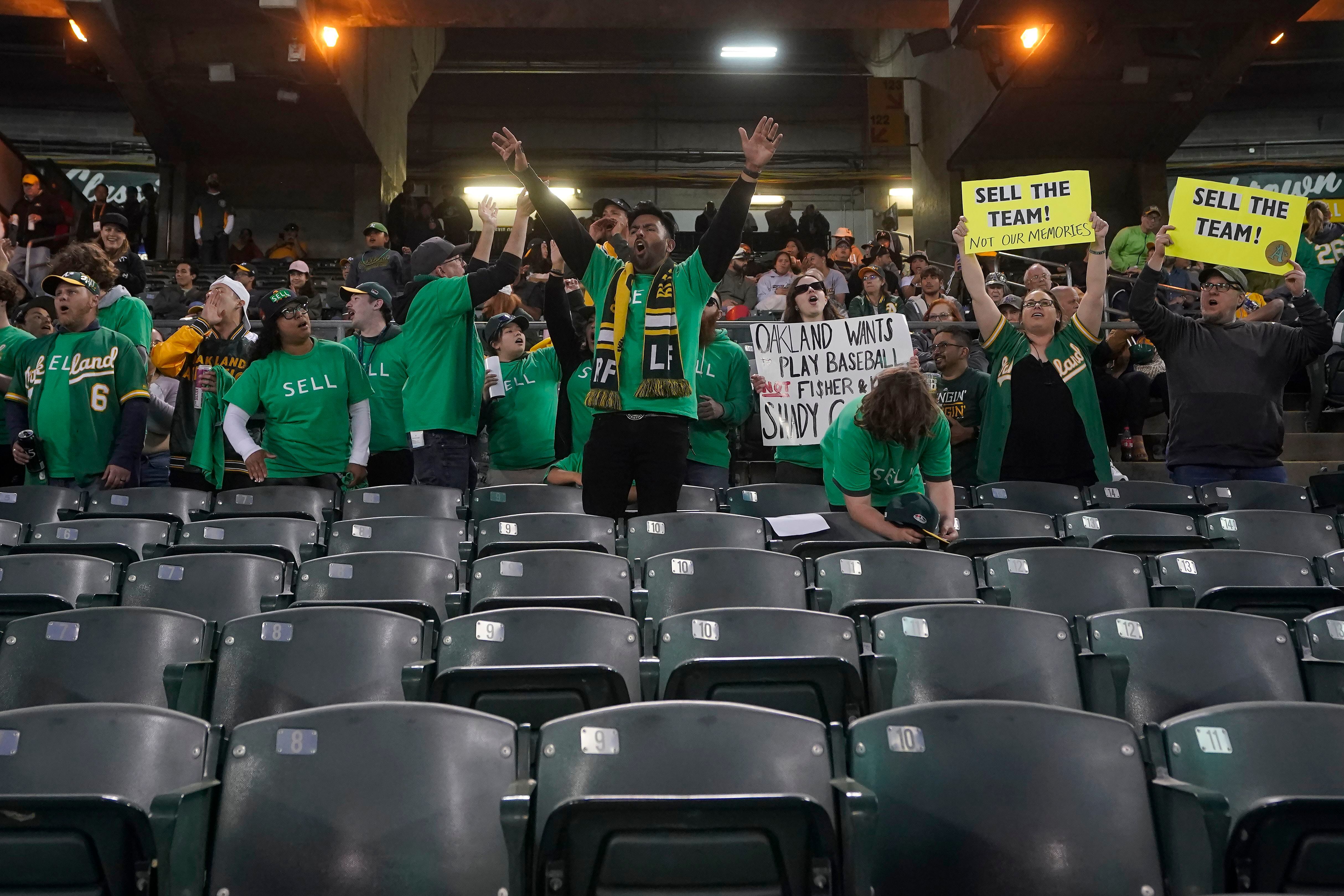 Oakland Athletics fans hang signs at RingCentral Coliseum to protest the  team's potential move to Las Vegas and to call for team owner John Fisher  to sell the team during a baseball