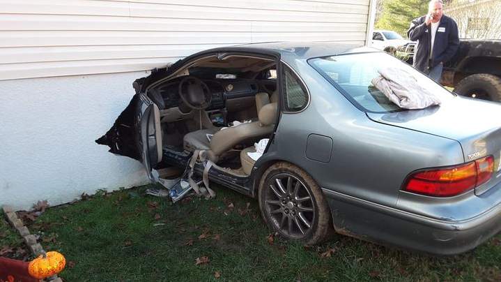 Car gets stuck into a Bedford house following crash