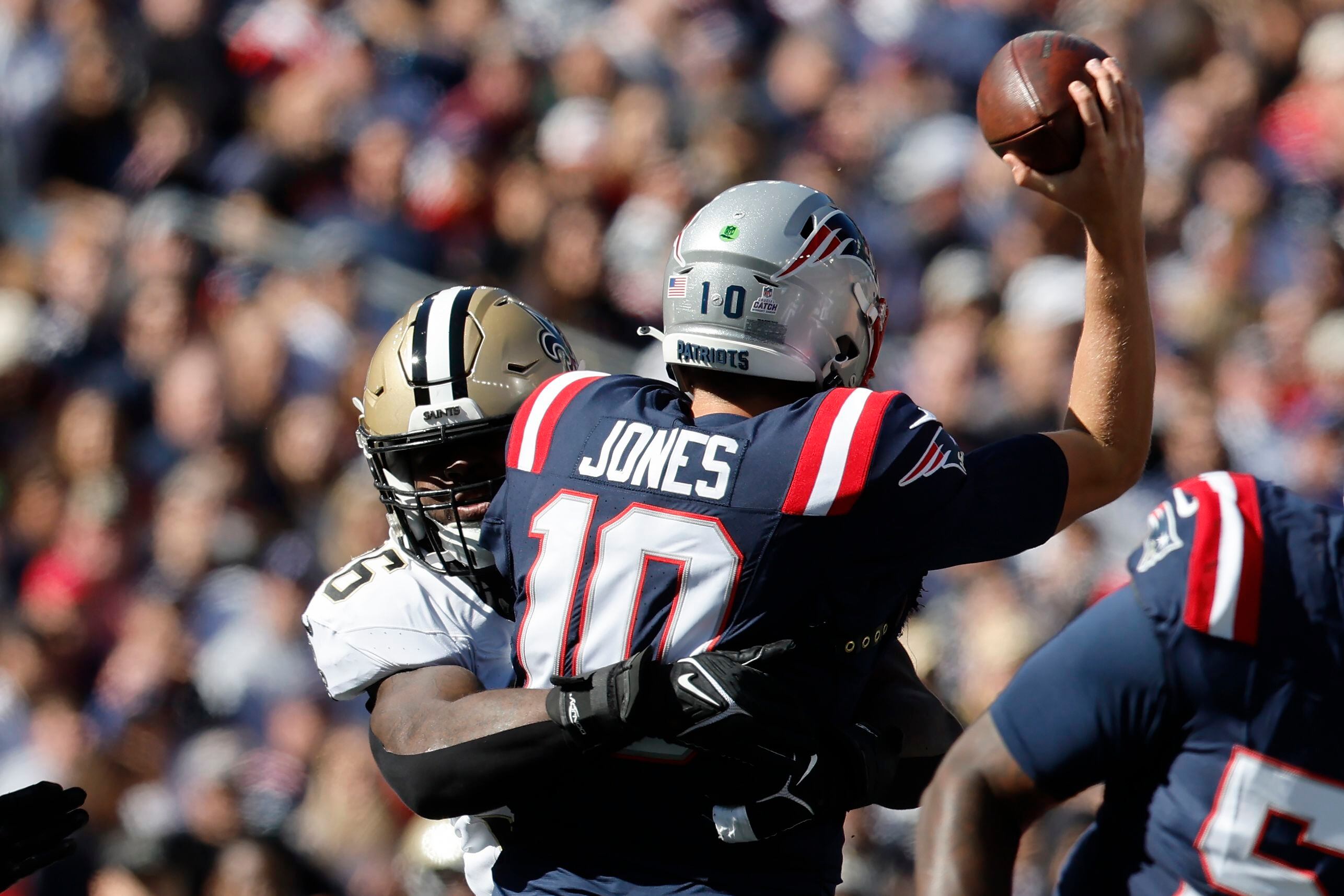 New England Patriots quarterback Mac Jones squeezes tight-window