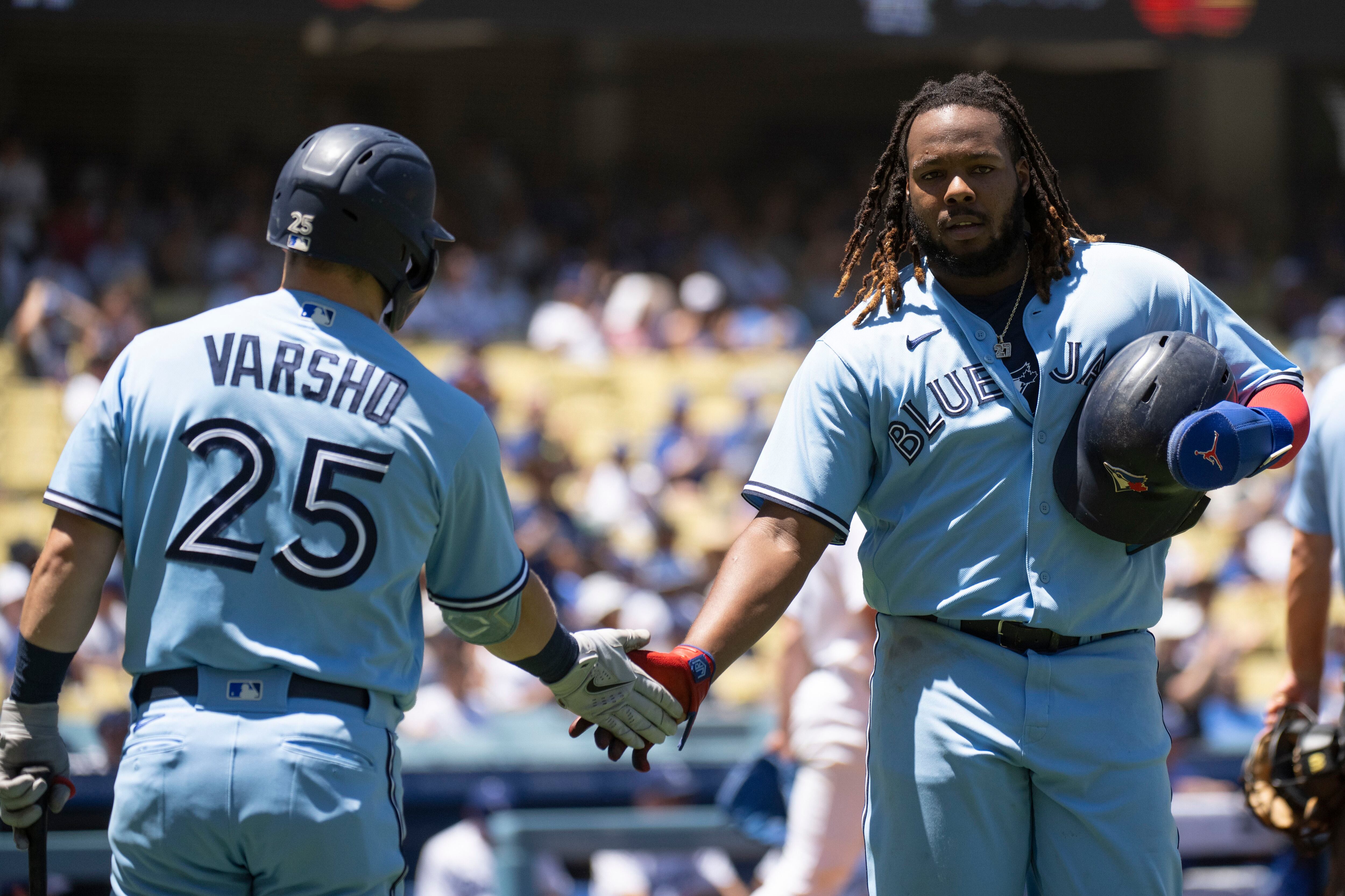 Toronto Blue Jays bench coach Don Mattingly, left, talks with first baseman  Vladimir Guerrero Jr. during