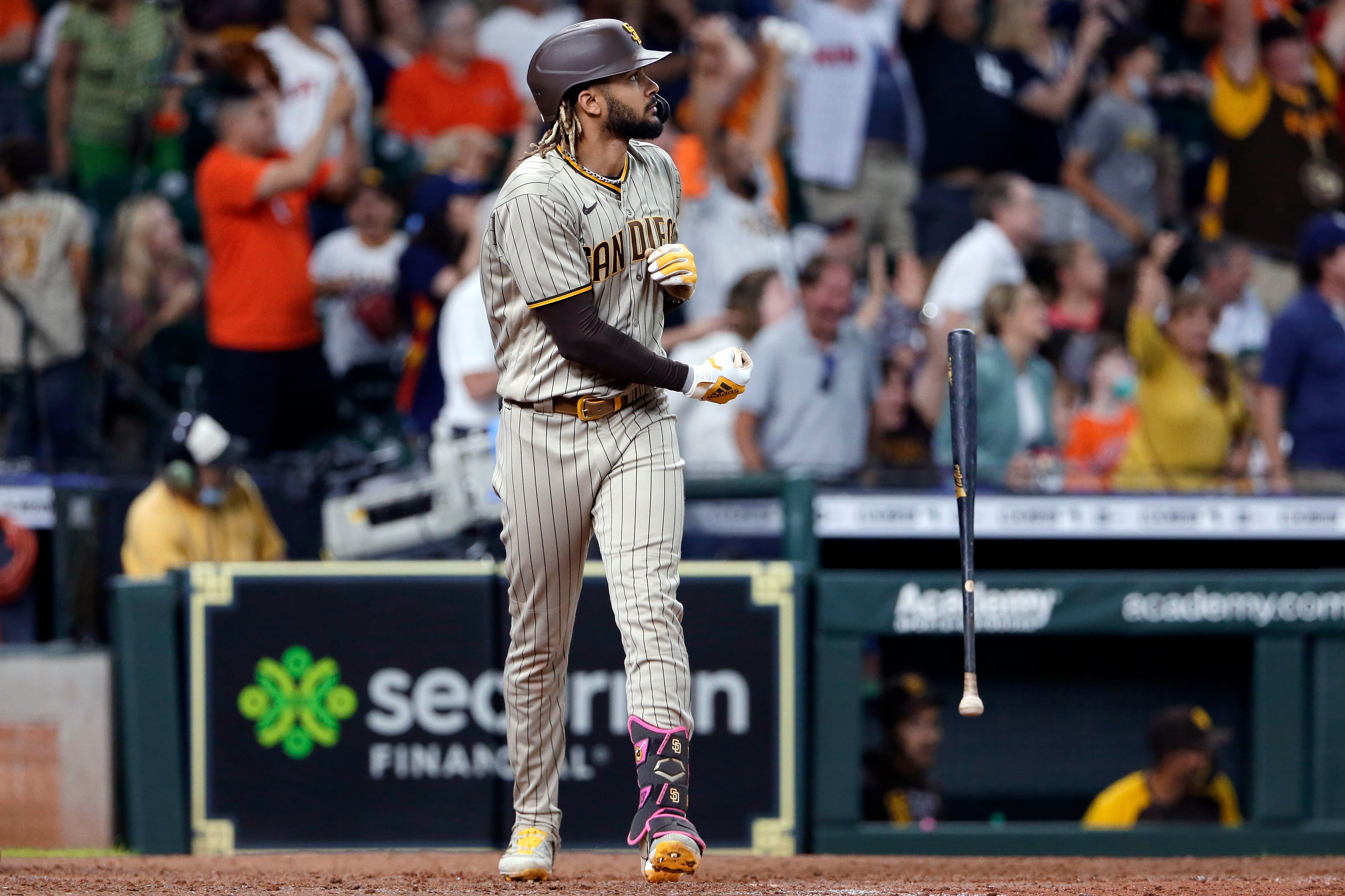 Fernando tatis jr in a padres jersey celebrating with a world