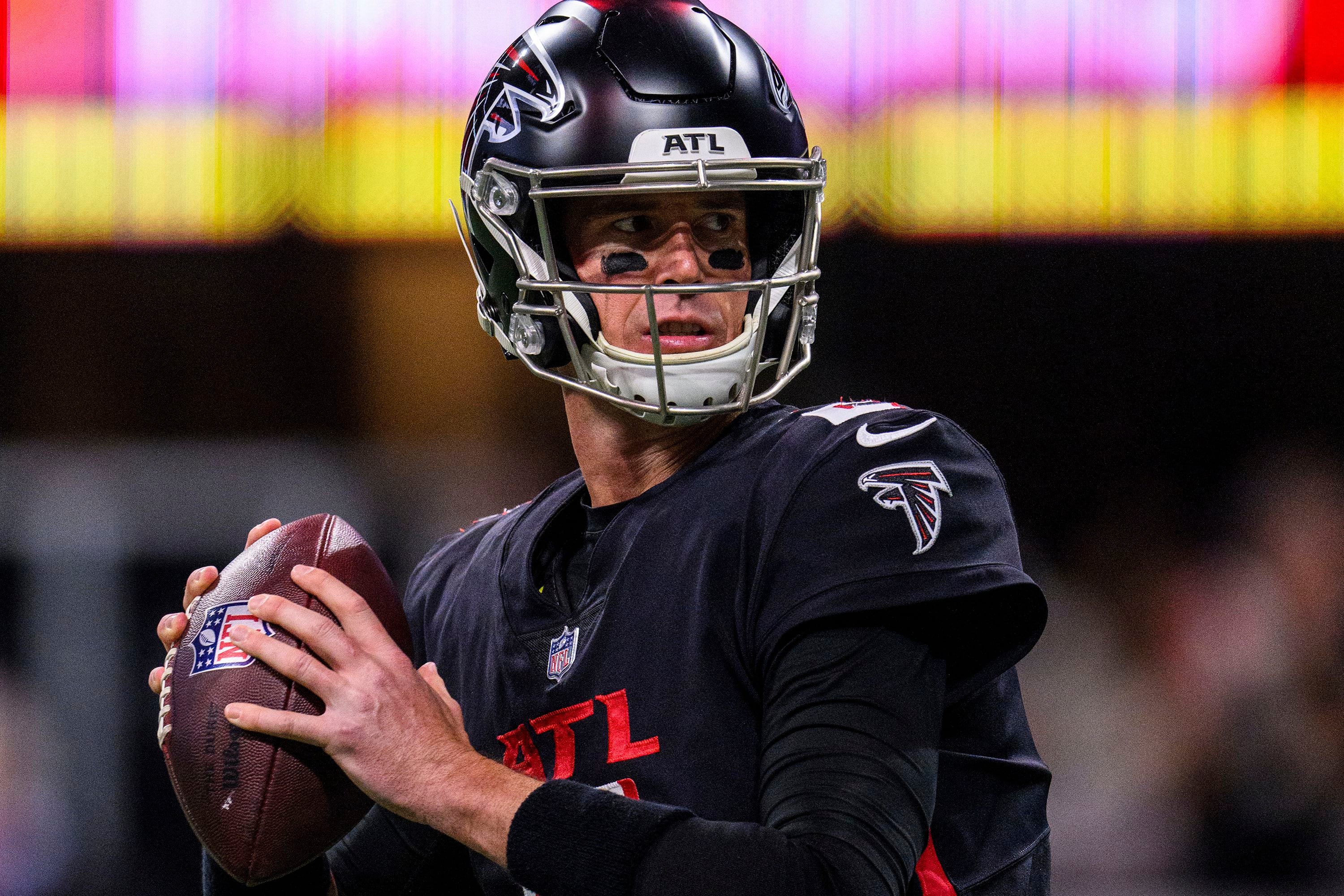 First look: Atlanta Falcons newly signed quarterback Marcus Mariota holding  his Falcons jersey, speaking with media