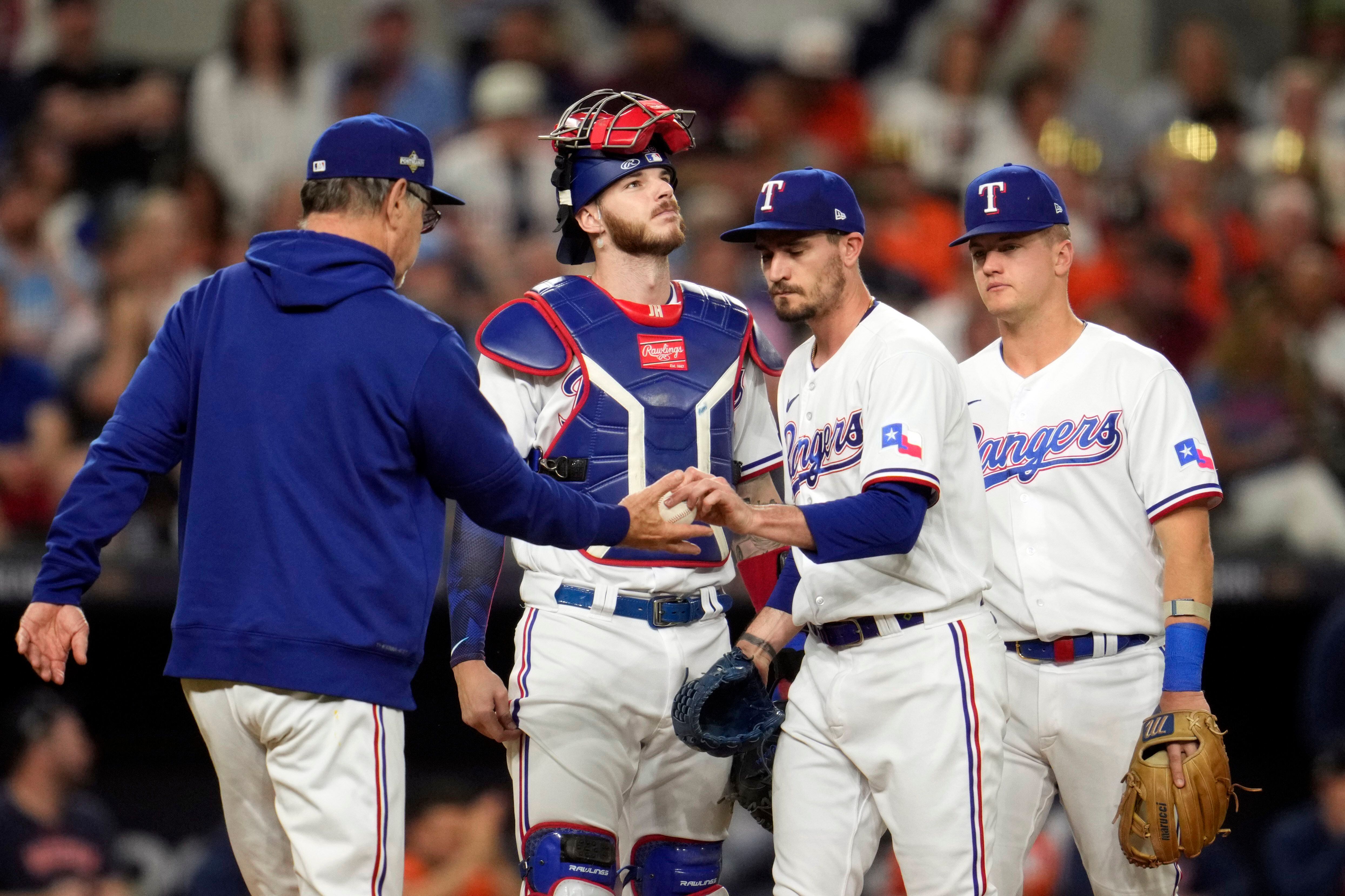 Texas Rangers manager Bruce Bochy walks to the mound to relieve