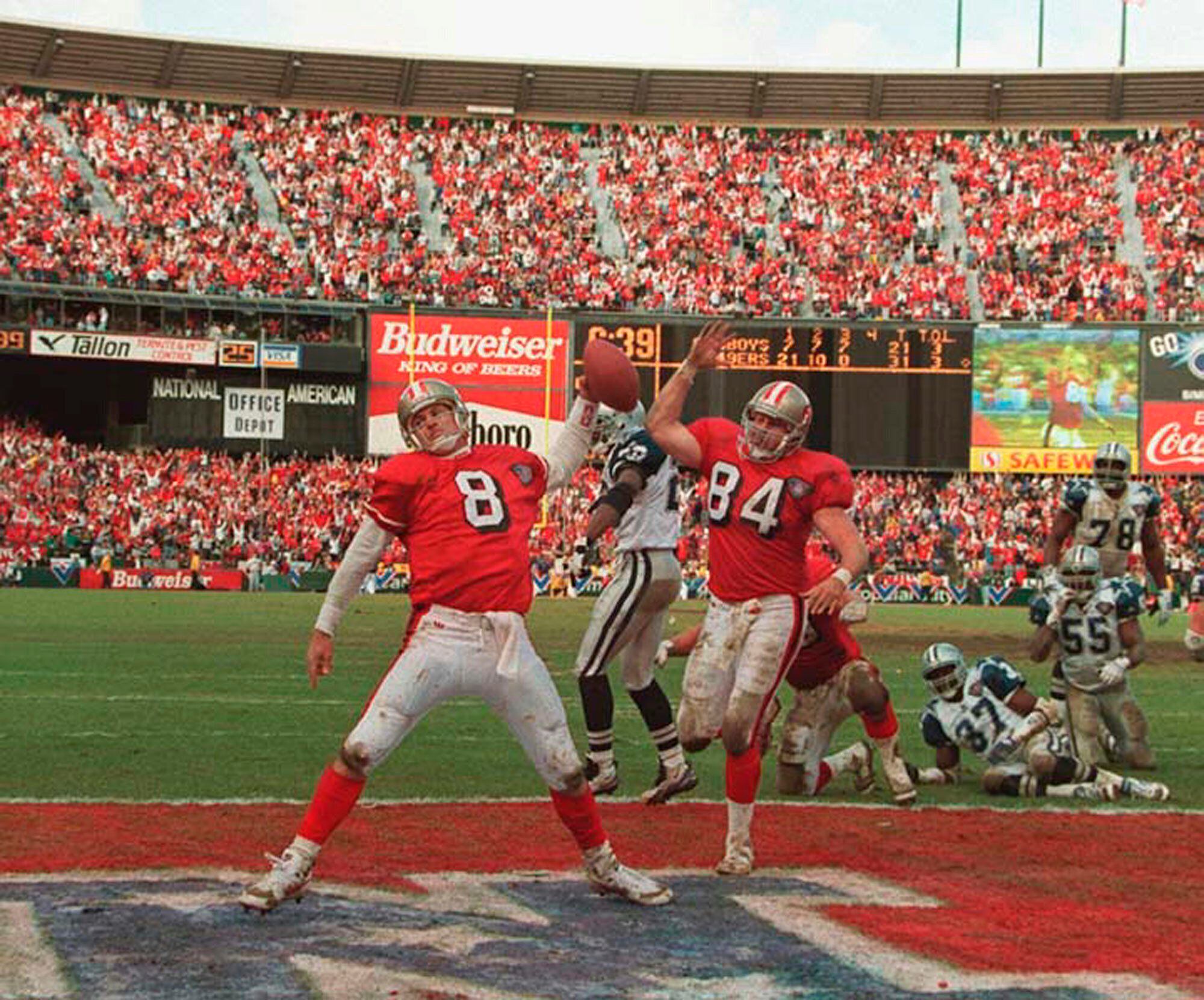 FILE - San Francisco 49ers quarterback Steve Young upends Dallas Cowboys  cornerback Deion Sanders after Sanders intercepted Young in the first  quarter of their Sunday, Nov 2, 1997, game in San Francisco.