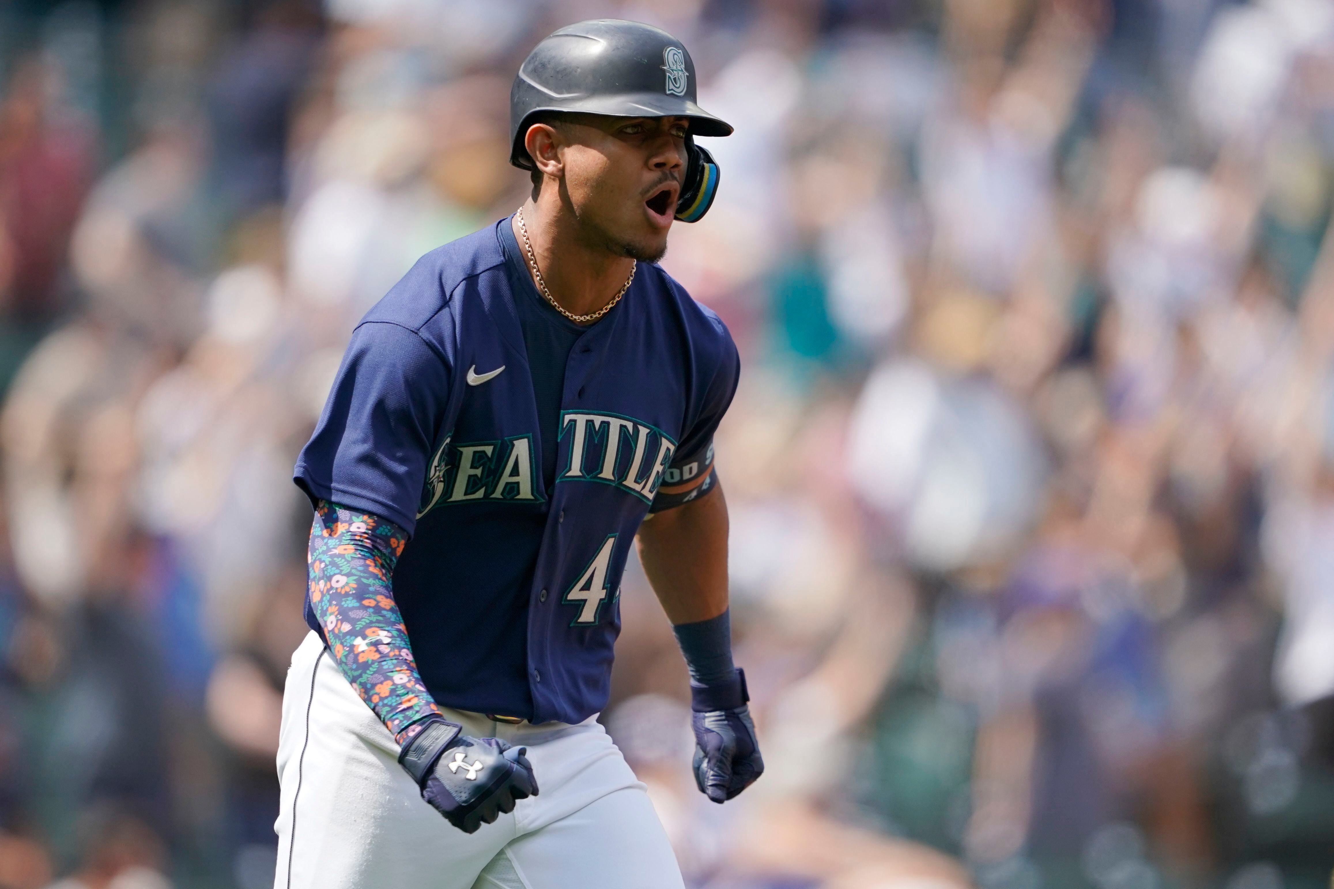 Seattle Mariners' Sam Haggerty walks to the dugout during a